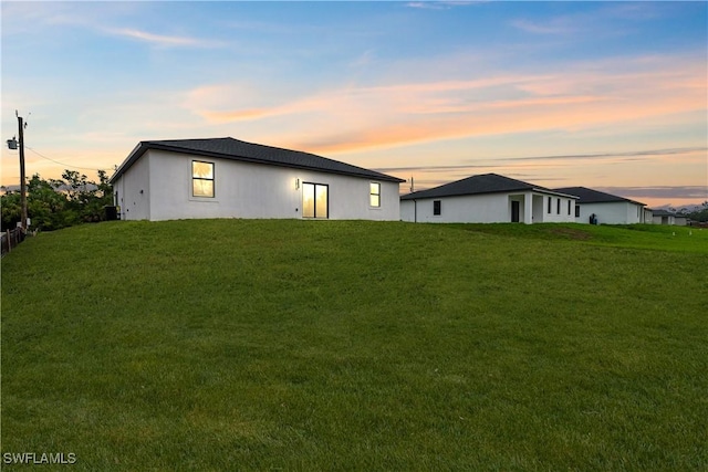 619 Greenbriar Blvd, Lehigh Acres, FL 33972 - back of house featuring a yard