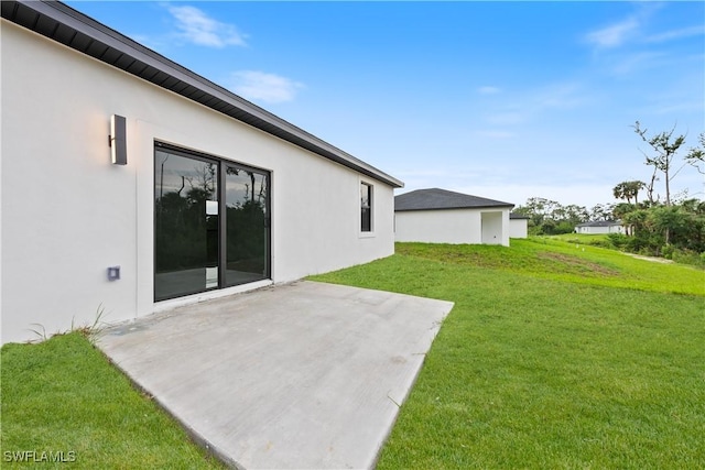 619 Greenbriar Blvd, Lehigh Acres, FL 33972 - view of green lawn with a patio