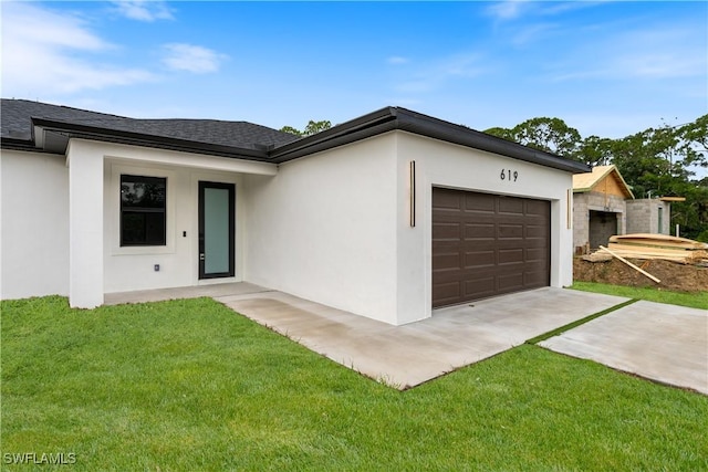 619 Greenbriar Blvd, Lehigh Acres, FL 33972 - view of front of home featuring a garage, concrete driveway, stucco siding, a front lawn, and roof with shingles
