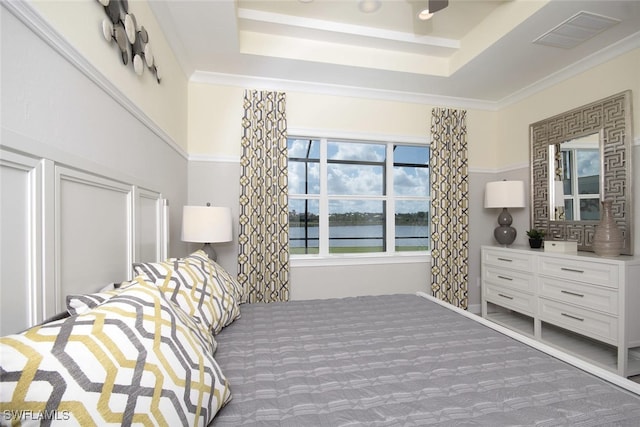 8881 Yucatan Ct, Naples, FL 34112 - bedroom featuring a tray ceiling, carpet flooring, a water view, and ornamental molding