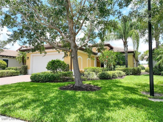 12490 Kentwood Ave, Fort Myers, FL 33913 - view of front of home with a garage, a front lawn, stucco siding, and a tiled roof