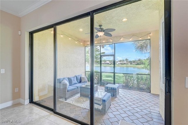12490 Kentwood Ave, Fort Myers, FL 33913 - doorway with ceiling fan, a water view, crown molding, and baseboards