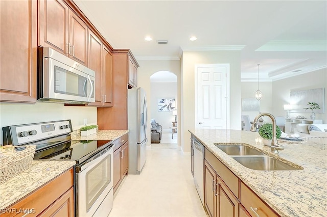 12490 Kentwood Ave, Fort Myers, FL 33913 - kitchen featuring appliances with stainless steel finishes, a sink, arched walkways, light stone counters, and ornamental molding