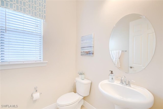12490 Kentwood Ave, Fort Myers, FL 33913 - half bath with a sink, toilet, plenty of natural light, and baseboards