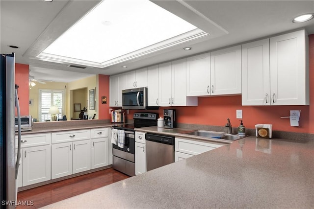 6979 Winkler Rd Unit 135, Fort Myers, FL 33919 - kitchen with appliances with stainless steel finishes, a sink, recessed lighting, white cabinetry, and dark wood finished floors
