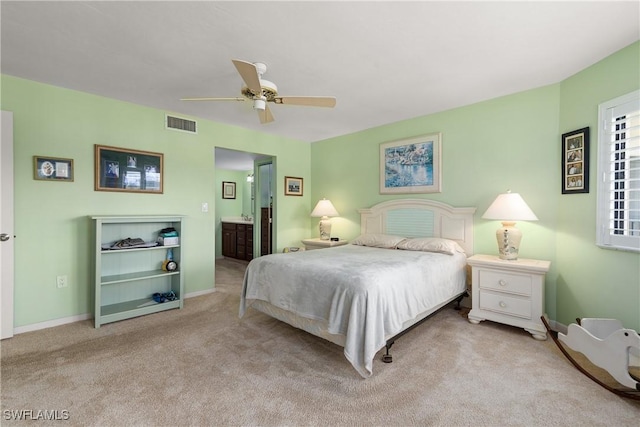 6979 Winkler Rd Unit 135, Fort Myers, FL 33919 - carpeted bedroom featuring baseboards, a ceiling fan, and ensuite bathroom