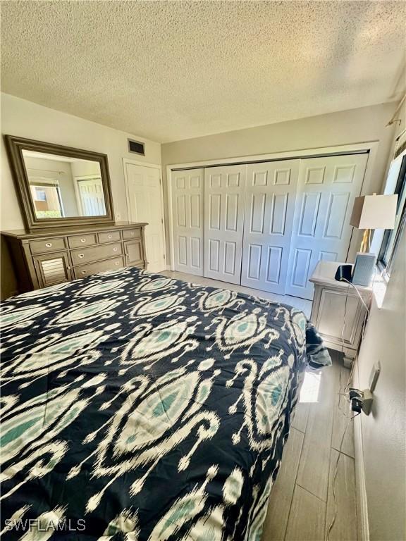 3625 Boca Ciega Dr Unit 110, Naples, FL 34112 - bedroom with a closet and a textured ceiling