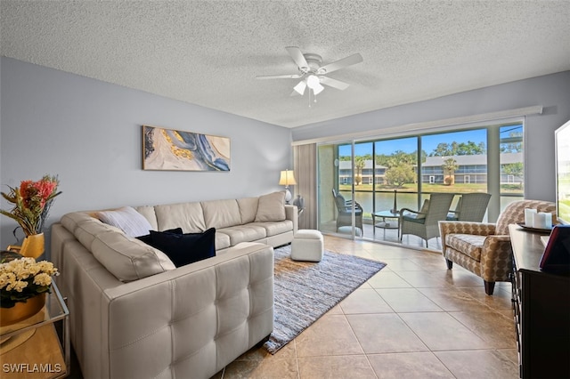 1210 Yesica Ann Cir Unit C105, Naples, FL 34110 - tiled living area with a ceiling fan, a textured ceiling, and a water view