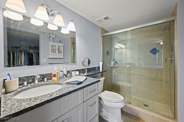 1210 Yesica Ann Cir Unit C105, Naples, FL 34110 - bathroom with a stall shower, toilet, vanity, and tile patterned flooring