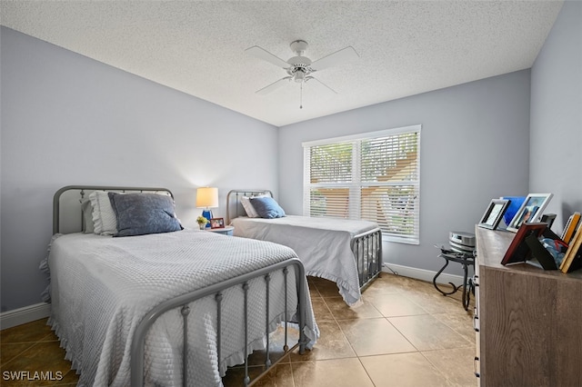 1210 Yesica Ann Cir Unit C105, Naples, FL 34110 - tiled bedroom featuring baseboards, a textured ceiling, and ceiling fan