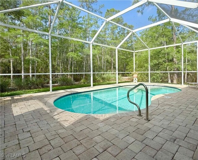 8736 Naples Heritage Dr, Naples, FL 34112 - outdoor pool featuring a patio area and a lanai
