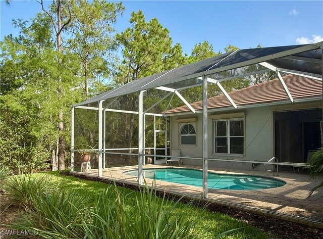 8736 Naples Heritage Dr, Naples, FL 34112 - swimming pool with a patio area and glass enclosure
