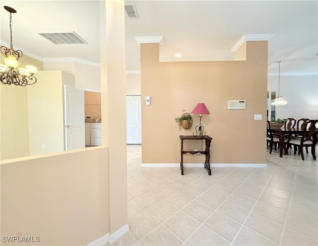 8736 Naples Heritage Dr, Naples, FL 34112 - corridor featuring a chandelier, ornamental molding, baseboards, washer / clothes dryer, and light tile patterned floors
