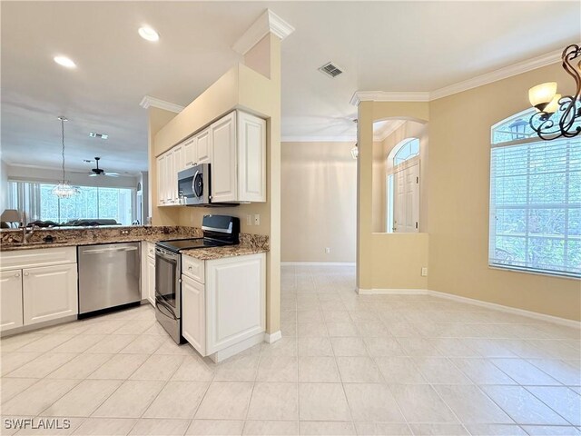 8736 Naples Heritage Dr, Naples, FL 34112 - kitchen featuring appliances with stainless steel finishes, a chandelier, dark stone countertops, crown molding, and baseboards