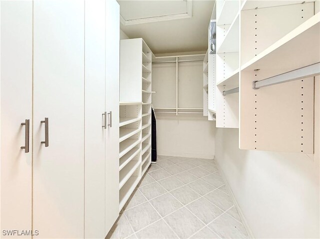 8736 Naples Heritage Dr, Naples, FL 34112 - spacious closet featuring light tile patterned flooring