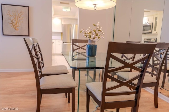 7150 Estero Blvd Unit 403, Fort Myers Beach, FL 33931 - dining area featuring light wood finished floors and baseboards