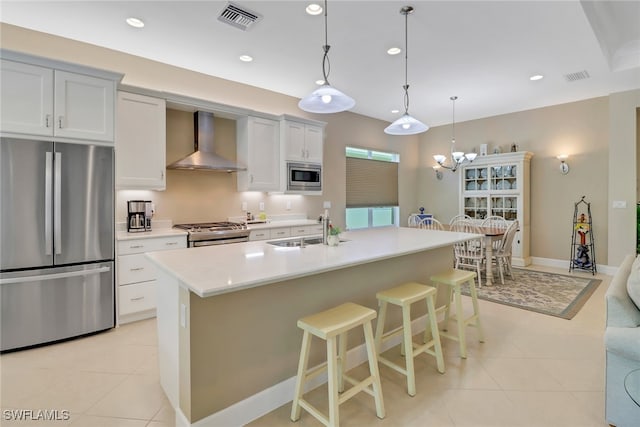 16712 Gilroy St, Bonita Springs, FL 34135 - kitchen with stainless steel appliances, wall chimney range hood, a sink, light tile patterned flooring, and recessed lighting