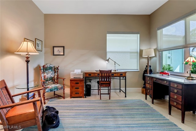 16712 Gilroy St, Bonita Springs, FL 34135 - home office with plenty of natural light, light tile patterned flooring, and baseboards