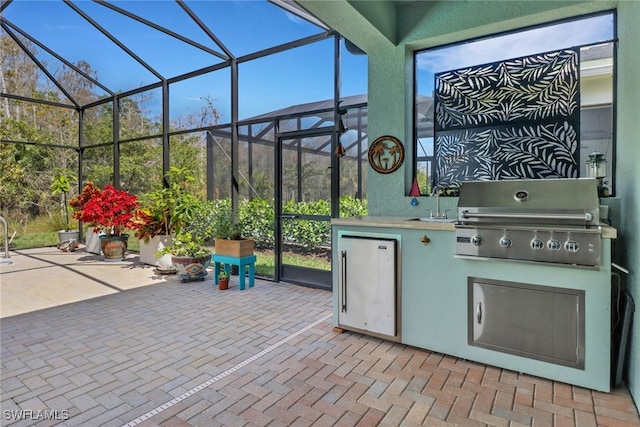 16712 Gilroy St, Bonita Springs, FL 34135 - view of patio featuring area for grilling, a lanai, exterior kitchen, and a sink