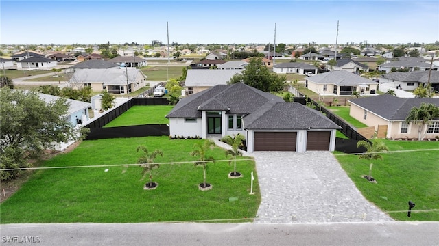 336 NE 25th St, Cape Coral, FL 33909 - view of front of house with a garage, a residential view, decorative driveway, and a shingled roof