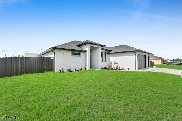 336 NE 25th St, Cape Coral, FL 33909 - prairie-style home featuring a garage, driveway, stucco siding, and roof with shingles