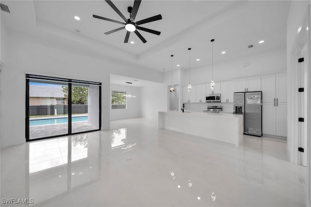 336 NE 25th St, Cape Coral, FL 33909 - unfurnished living room with a ceiling fan, a sink, recessed lighting, a towering ceiling, and light tile patterned flooring