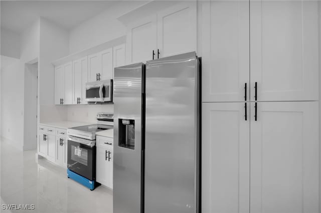 336 NE 25th St, Cape Coral, FL 33909 - kitchen with stainless steel appliances, white cabinetry, and light countertops