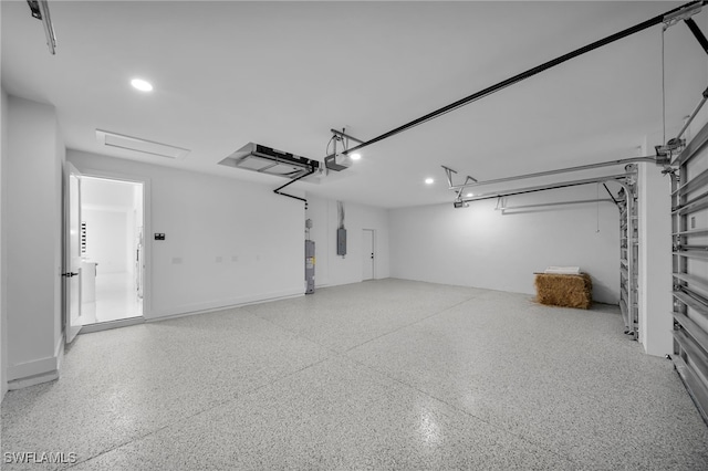 336 NE 25th St, Cape Coral, FL 33909 - garage featuring electric water heater, recessed lighting, electric panel, and a garage door opener