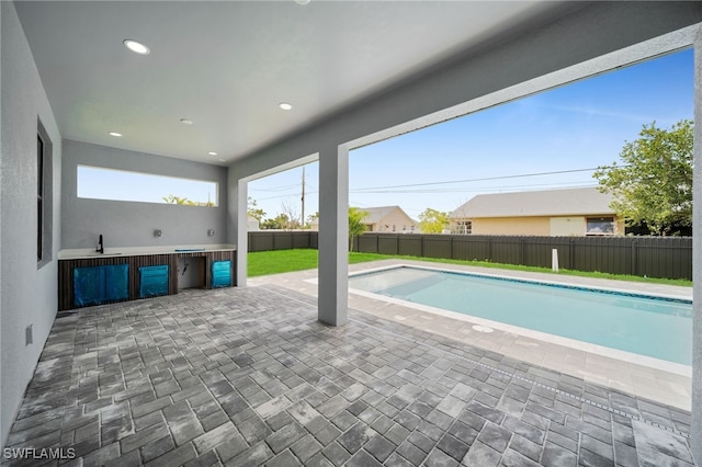 336 NE 25th St, Cape Coral, FL 33909 - view of swimming pool with a fenced backyard, a patio, and a sink