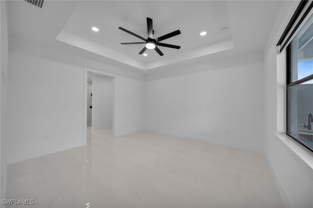 336 NE 25th St, Cape Coral, FL 33909 - spare room with a raised ceiling, recessed lighting, a ceiling fan, and baseboards