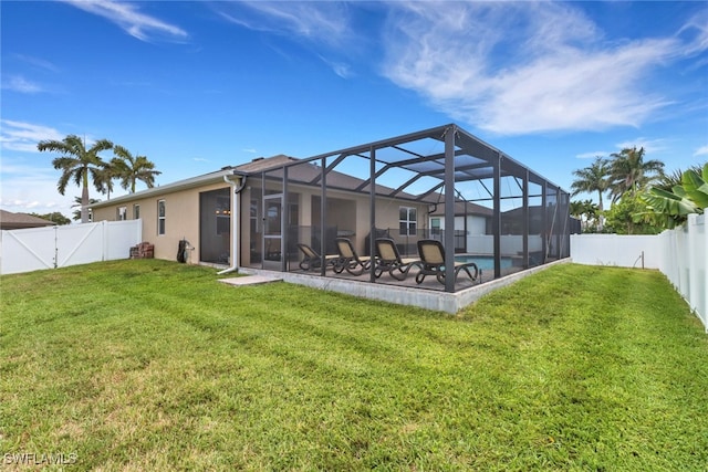2510 SW 24th Ct, Cape Coral, FL 33914 - rear view of house featuring a patio, glass enclosure, stucco siding, and a gate