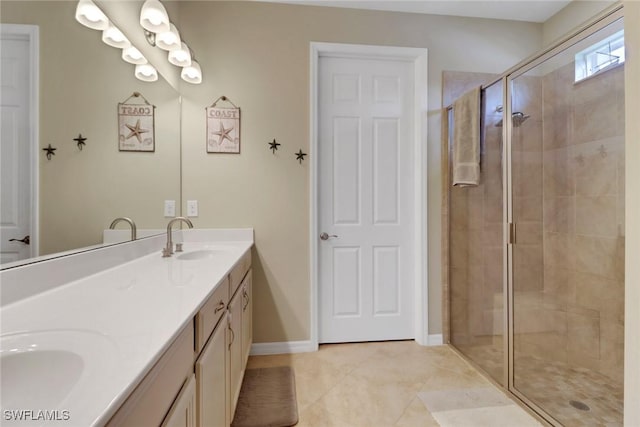 2510 SW 24th Ct, Cape Coral, FL 33914 - bathroom featuring double vanity, a shower stall, tile patterned floors, and baseboards