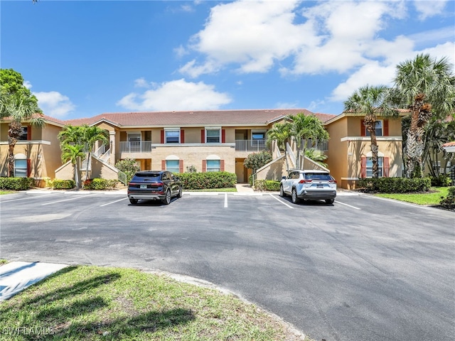6670 Huntington Lakes Cir Unit 104, Naples, FL 34119 - view of building exterior with uncovered parking