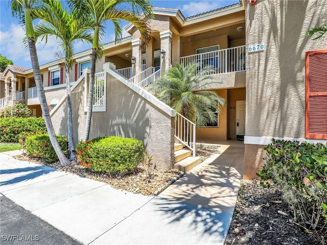 6670 Huntington Lakes Cir Unit 104, Naples, FL 34119 - view of building exterior featuring stairs