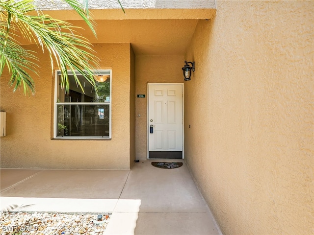 6670 Huntington Lakes Cir Unit 104, Naples, FL 34119 - property entrance with stucco siding