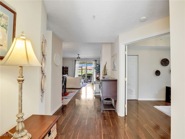 6670 Huntington Lakes Cir Unit 104, Naples, FL 34119 - corridor featuring wood finished floors, baseboards, and a textured ceiling