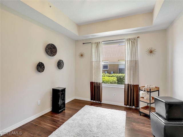 6670 Huntington Lakes Cir Unit 104, Naples, FL 34119 - sitting room featuring dark wood-style floors, baseboards, and a raised ceiling