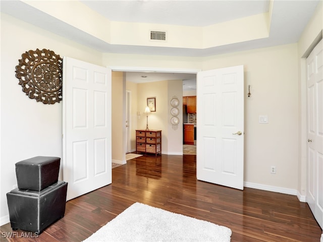 6670 Huntington Lakes Cir Unit 104, Naples, FL 34119 - bedroom featuring dark wood-style flooring and baseboards