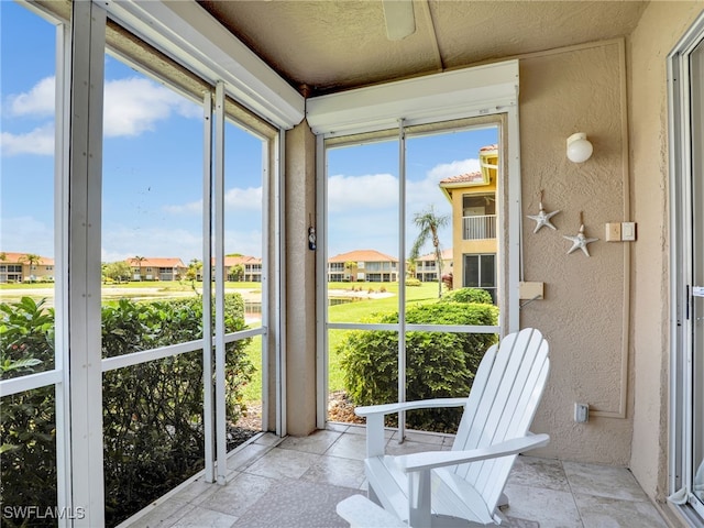 6670 Huntington Lakes Cir Unit 104, Naples, FL 34119 - sunroom with a textured wall and a residential view