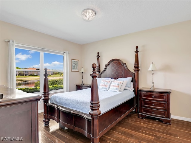 6670 Huntington Lakes Cir Unit 104, Naples, FL 34119 - bedroom with dark wood-style floors and baseboards