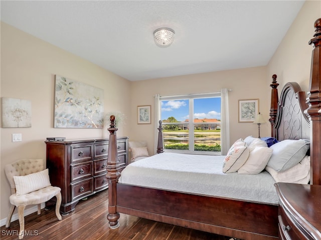6670 Huntington Lakes Cir Unit 104, Naples, FL 34119 - bedroom with dark wood-style flooring