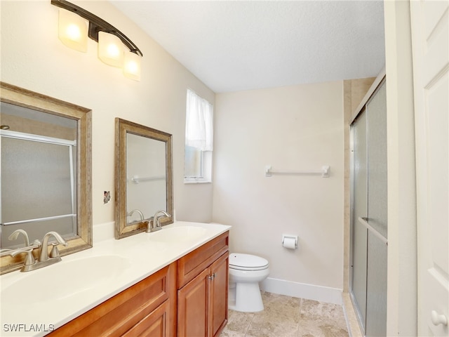 6670 Huntington Lakes Cir Unit 104, Naples, FL 34119 - full bath featuring double vanity, toilet, a shower with shower door, and baseboards
