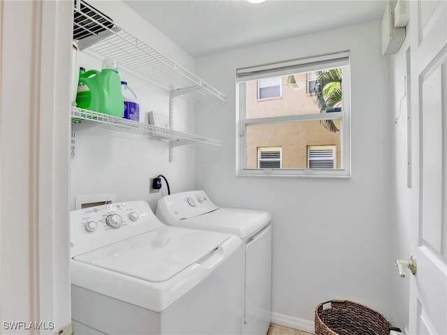 6670 Huntington Lakes Cir Unit 104, Naples, FL 34119 - washroom with washing machine and dryer and baseboards