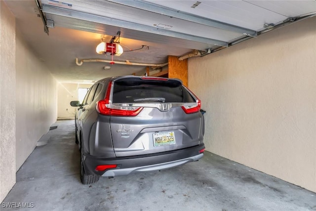 5015 Harbortown Ln Unit 204, Fort Myers, FL 33919 - garage with a garage door opener and a textured wall