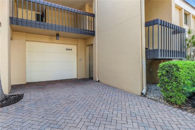 5015 Harbortown Ln Unit 204, Fort Myers, FL 33919 - garage featuring decorative driveway