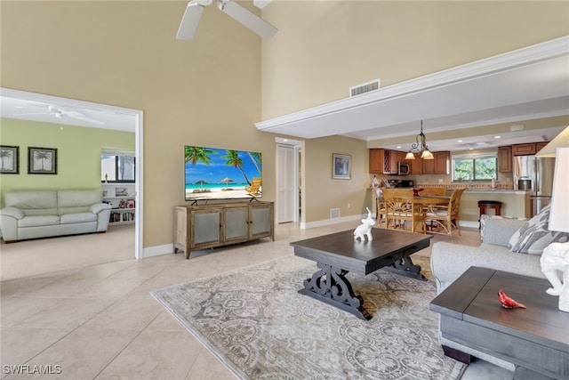5015 Harbortown Ln Unit 204, Fort Myers, FL 33919 - living room with a ceiling fan, a high ceiling, light tile patterned flooring, and baseboards