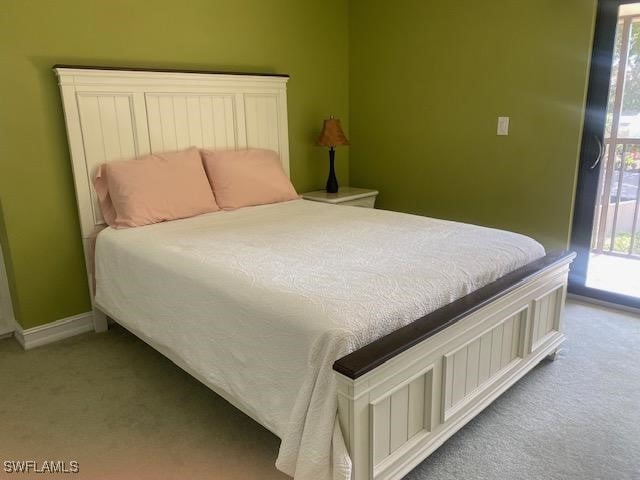 5015 Harbortown Ln Unit 204, Fort Myers, FL 33919 - bedroom with carpet, access to outside, and baseboards