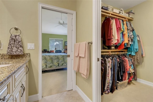 5015 Harbortown Ln Unit 204, Fort Myers, FL 33919 - walk in closet featuring light carpet and ceiling fan