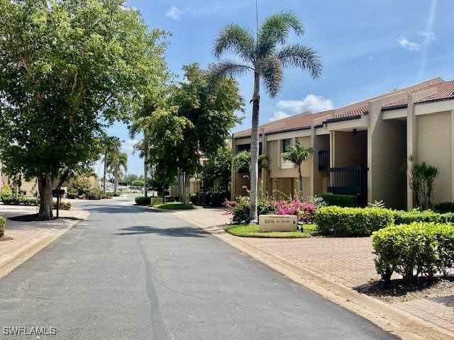 5015 Harbortown Ln Unit 204, Fort Myers, FL 33919 - view of asphalt road with curbs