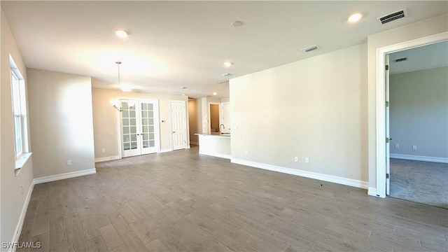 986 Enbrook Loop, Naples, FL 34114 - unfurnished living room featuring dark wood-style floors, baseboards, a chandelier, recessed lighting, and french doors